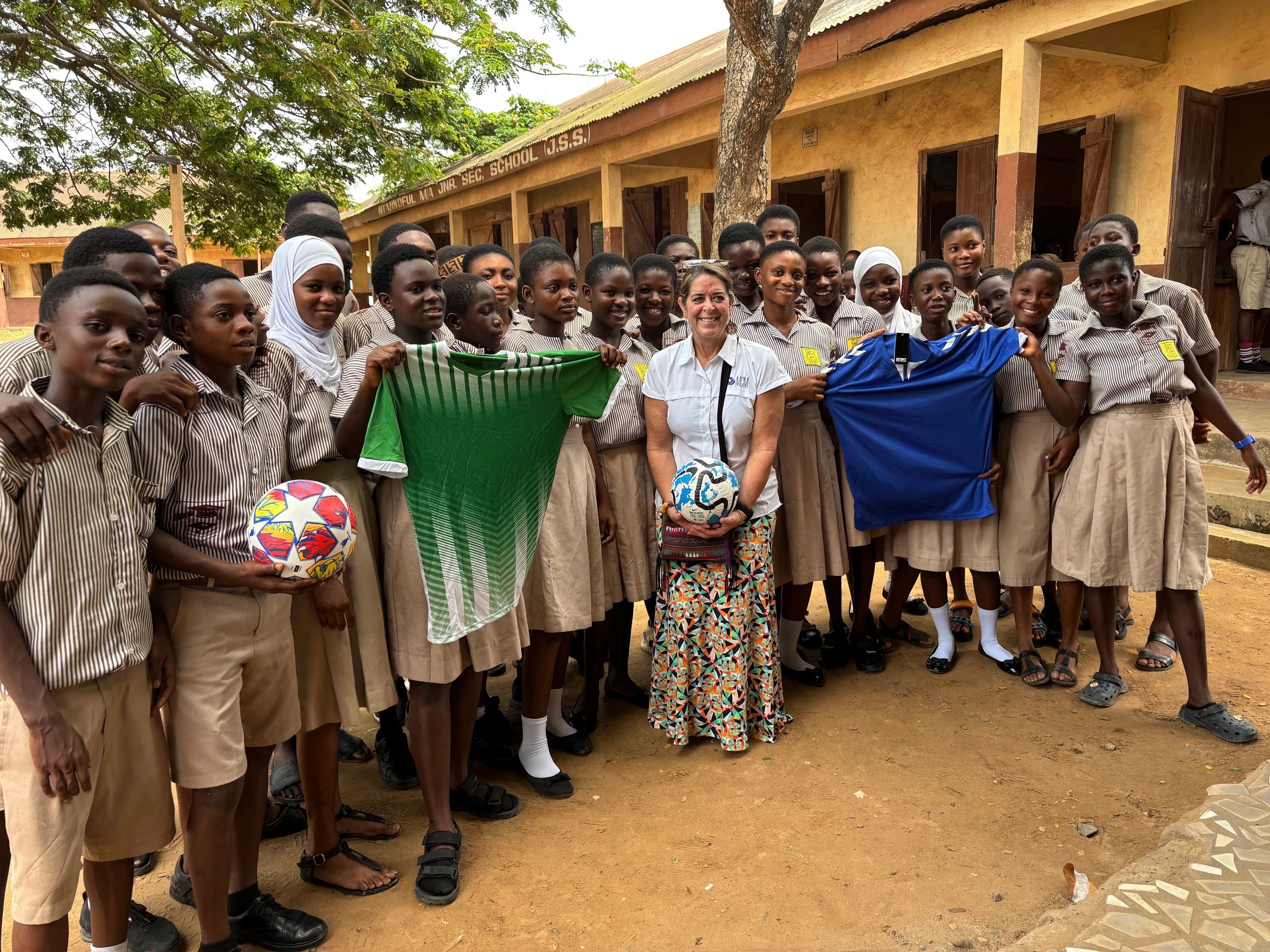 Jaida Campbell distributing sports gear to students on a mission trip